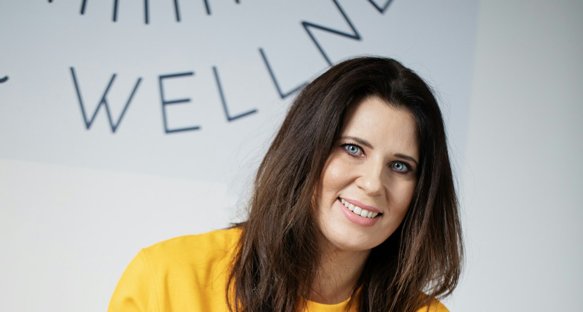 Smiling woman expressing self-confidence and wellbeing — photo by Margaret Young on Unsplash